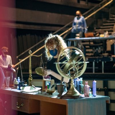 Production Arts student putting out props on stage for a rehearsal